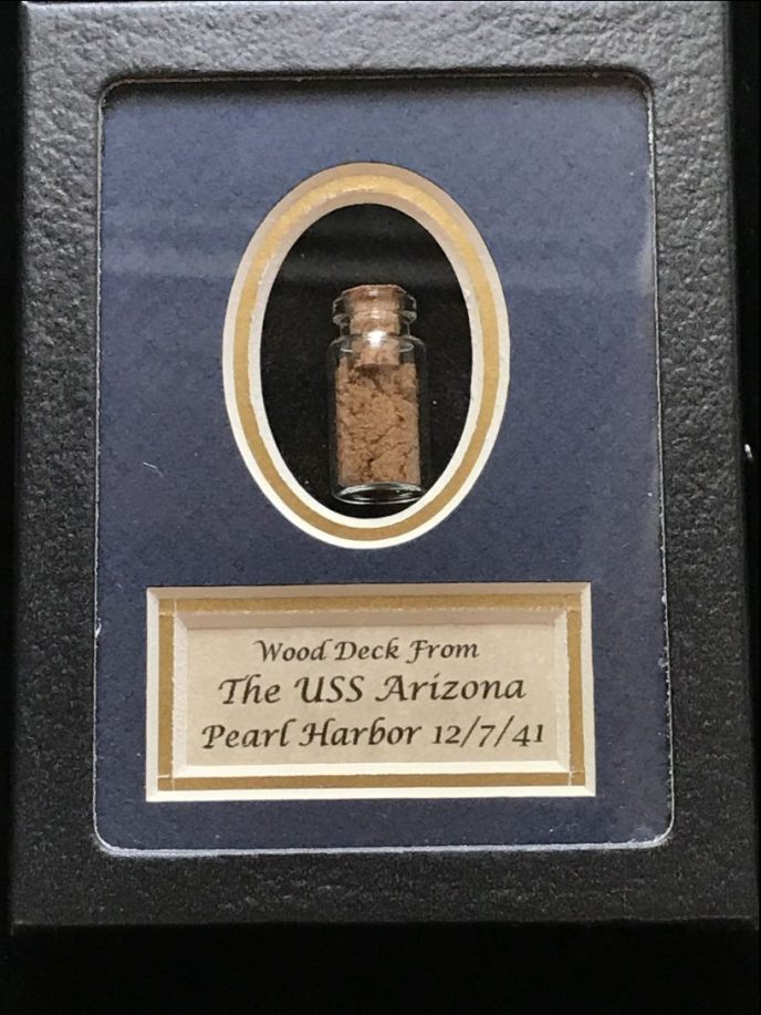 Original wood from the deck of the USS Arizona, preserved in a collector's glass case, certified by the Gettysburg Museum of History