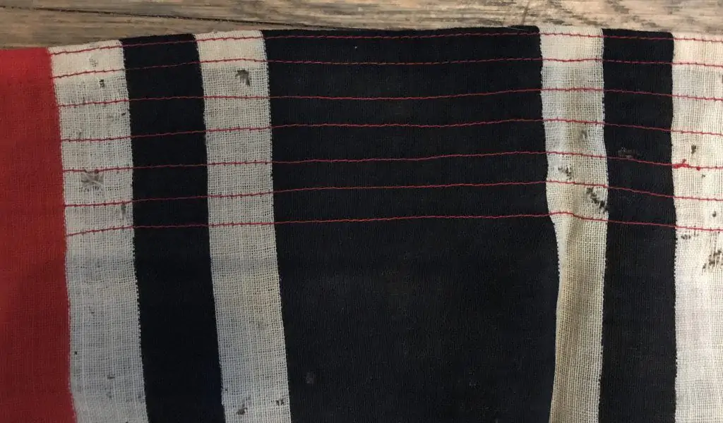 Close-up of a WWII German Reichskriegsflagge, showing detailed stitching and insignia