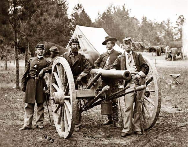 Civil War cannon used by soldiers in artillery shell jackets