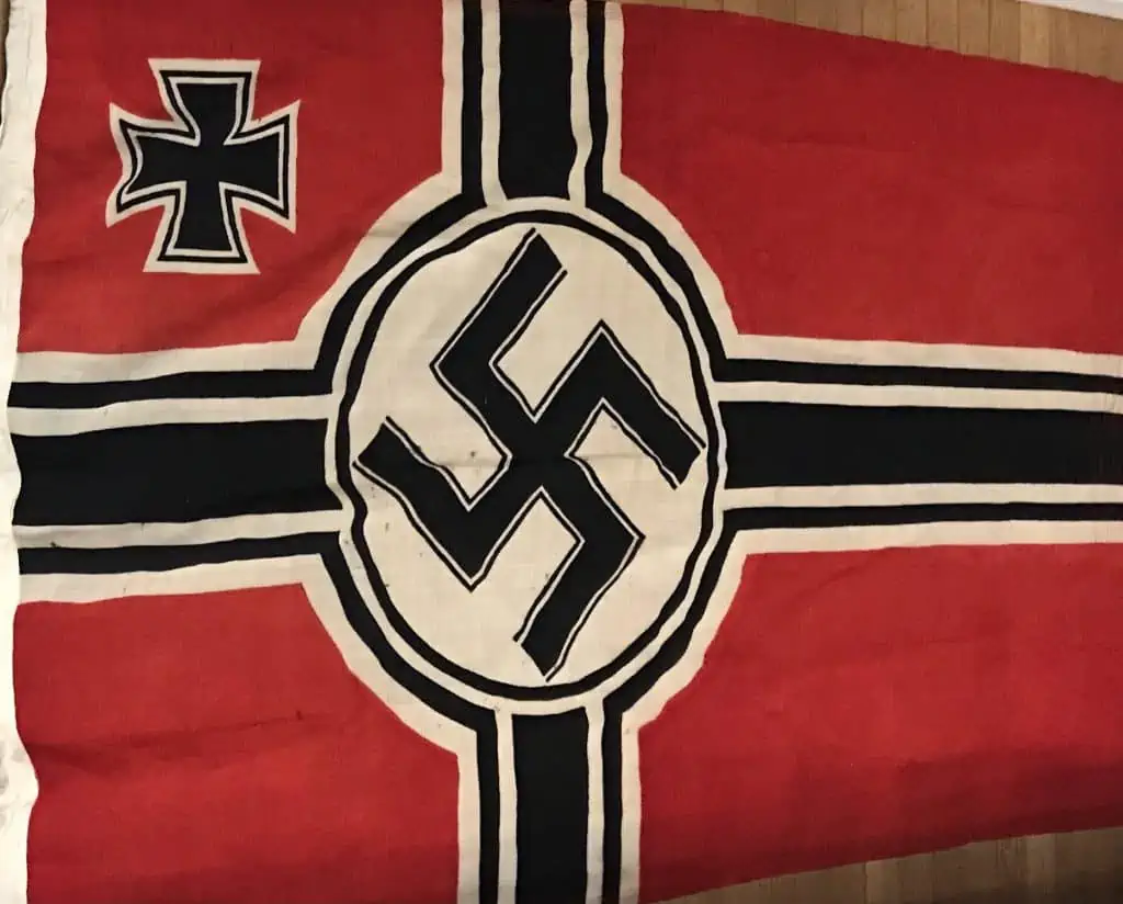 Full view of a WWII German Nazi national war flag, displayed as part of a military collection