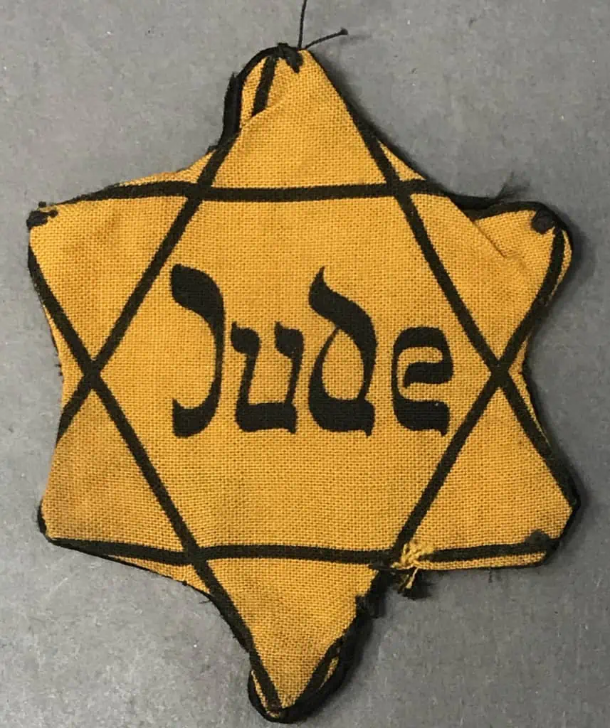 Close-up of a worn Star of David badge with 'Jude' marking, a rare Holocaust-era artifact