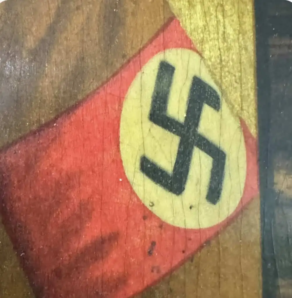 Close-up of Adolf Hitler color portrait on wood, showing facial details