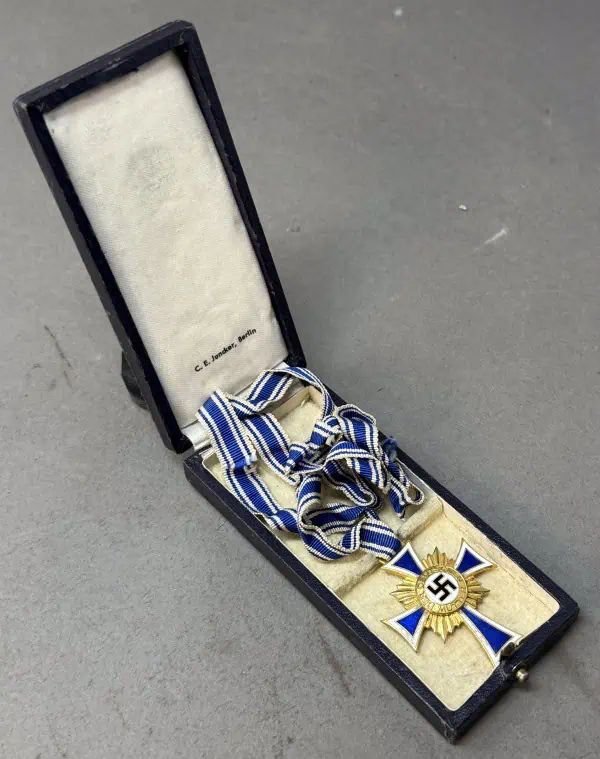 Medal with swastika symbol in a black presentation box, likely a historical or military artifact.