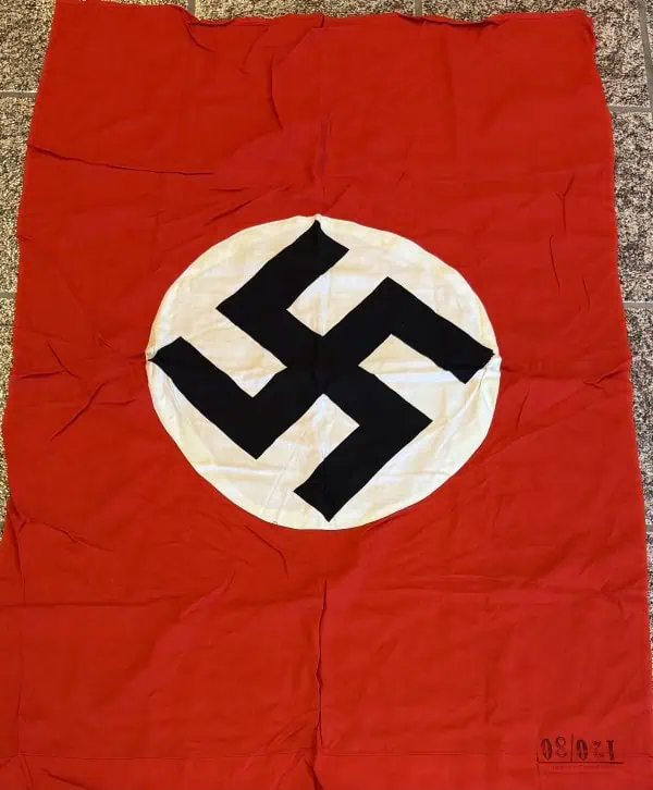 Swastika Nazi flag with red background and black symbol on white circle.