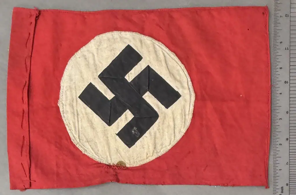Swastika flag with red background and white circle, historical Nazi symbol.