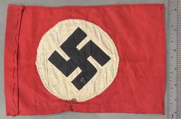 Swastika flag with red background and white circle, historical Nazi symbol.